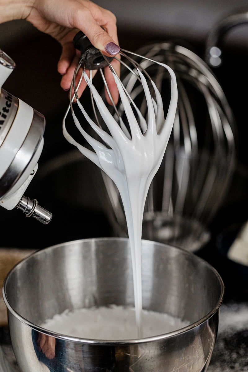 handcrafted marshmallow batter dripping from whisk